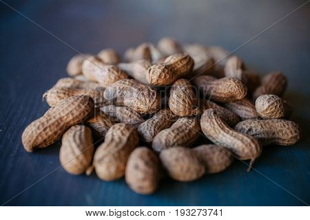 Peanut in shell texture and background. Peanuts texture. Shelled Peanuts. Healthy food. Close up view of shelled peanuts in wooden background. Abstract background and texture for designers.