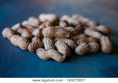 Peanut in shell texture and background. Peanuts texture. Shelled Peanuts. Healthy food. Close up view of shelled peanuts in wooden background. Abstract background and texture for designers.
