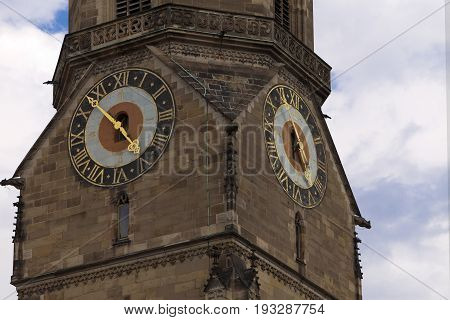 tower clock on Stiftskirche church bell tower in Stuttgart in Germany