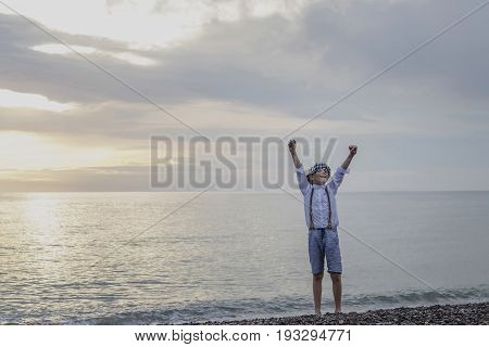 the boy at the top of an old tyre