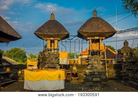 BALI, INDONESIA - MARCH 11, 2017: Entrance of an Indu temple in Ubud, with some straw huts located in the backyard in the island of Bali, located in Indonesia.