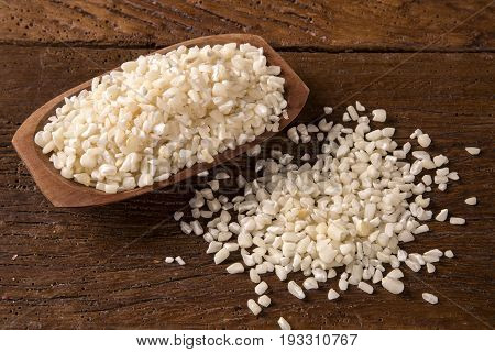 White Grated Corn Kernels In Wooden Bowl. Canjica / Mungunza