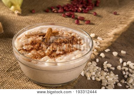 Brazilian Dessert Canjica Of White Corn With Cinnamon In Transparent Plate.