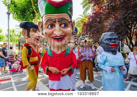 Badajoz, Spain - june 24, 2017: Disguised figures known as giants and big heads,  roughly gigantes y cabezudos parade for the children in the city of Badajoz