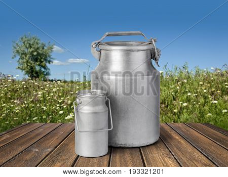 Retro can for milk on wooden table withy clipping path