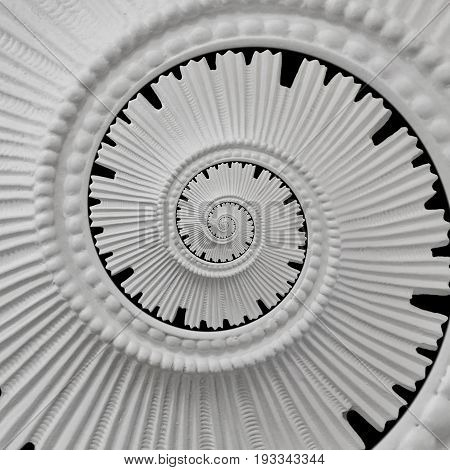White black stucco moulding plasterwork spiral abstract fractal pattern background. Plaster abstract spiral effect background. Spiral abstract background. Decorative stucco element concept fractal