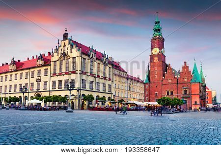 Colorful Evening Scene On Wroclaw Market Square With Town Hall.