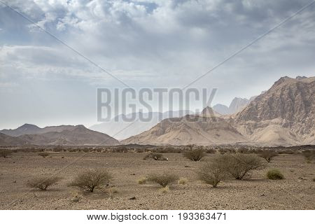 clouds over landscape of Hajjar Mountains in Oman