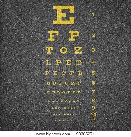 Eye chart painted over dark asphalt background