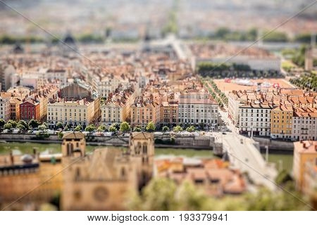 Aerial cityscape view on Lyon with Rhone river during the morning light in France. Tilt-shift image technic