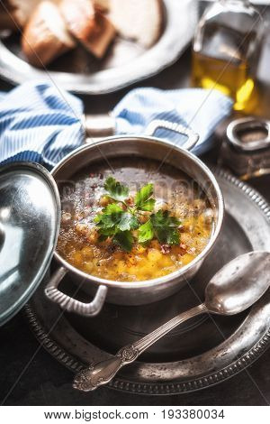 Greek chickpea soup in the pot on the stone background vertical