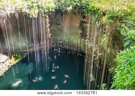 Chichen Itza Mexico - April 18 2016: Tourists bathing in the Ik Kil sinkhole