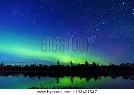 Night Sky Full Of Stars And A Hint Of The Milky Way Galaxy Above Beautiful Green Northern Lights