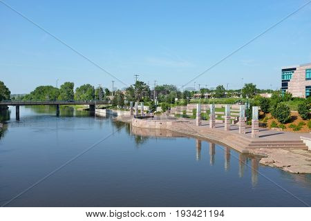 SIOUX FALLS, SOUTH DAKOTA - JUNE 21, 2017: Riverwalk park along the Big Sioux River. Parks, hotels, restaurants and footbridges, line the popular area along the cities revitalized downtown district.