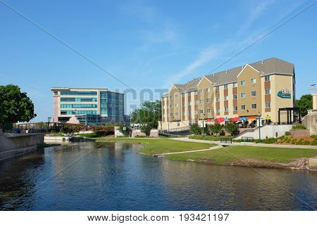 SIOUX FALLS, SOUTH DAKOTA - JUNE 21, 2017: Riverwalk along the Big Sioux River. Parks, hotels, restaurants and footbridges, line the popular area along the cities revitalized downtown district.
