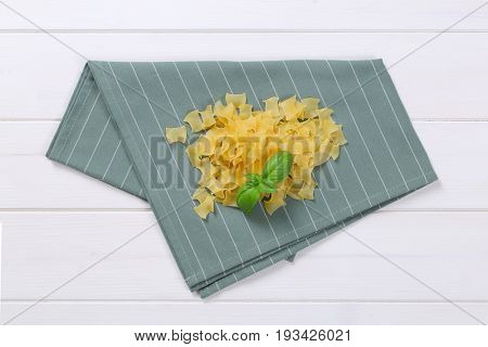 pile of quadretti - square shaped pasta on grey place mat