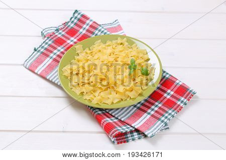 plate of quadretti - square shaped pasta on checkered place mat
