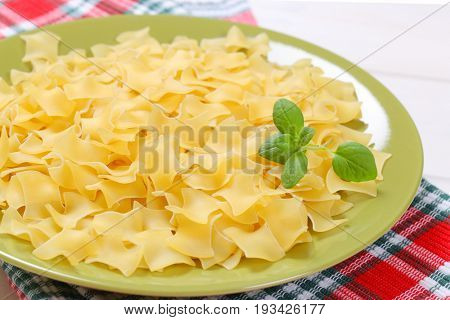 plate of quadretti - square shaped pasta on checkered place mat - close up