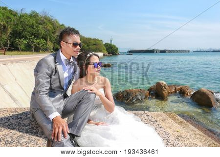 Asian couples fashion photography in pre wedding photos on coast of Koh Si Chang in concept of love and family life.