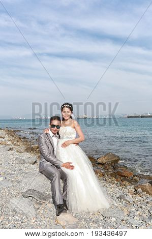 Asian couples fashion photography in pre wedding photos on coast of Koh Si Chang in concept of love and family life.