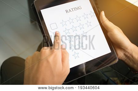 blurred of customer survey checking in online survey rating feedback on smart phone with multiple-choice assessment by finger clicking : business concept