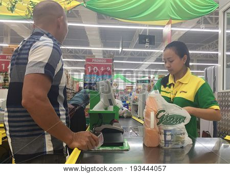 Keningau,Sabah-June 23,2017:Customer make payment for buying goods with cash in the counter of Giant Malaysian Supermarket in Keningau,Sabah.Giant,pioneered the concept of modern supermarket shopping.