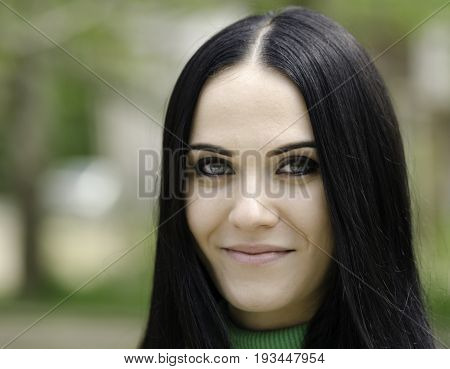 Young pretty brunette walking in a park