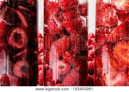 Macro Shoot Detox Water In Three Bottles With Berries. Close-up