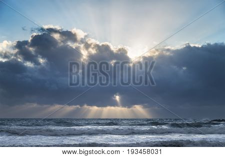 Stuning Cloud Formations Over Sea At Sunset With Precuspular Sun Beams Through Clouds