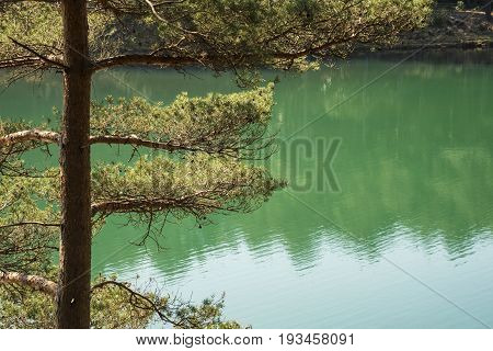 Beautiful Vibrant Landscape Image Of Old Clay Pit Quarry Lake With Unusual Colored Green Water