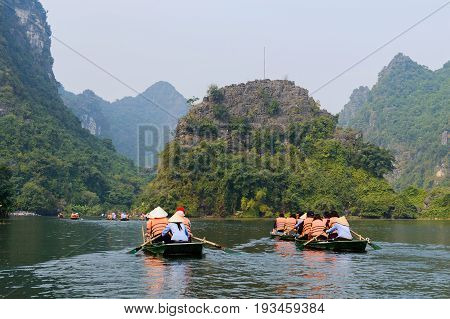International Tourists Traveling On Local Vietnamese Small Boat