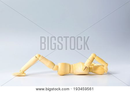 Wooden figure doll with sit up for health on white for exercise training and helth concept.