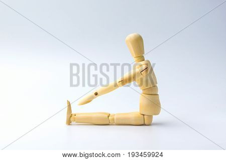 Wooden figure doll with Stretch arms and leg on white for exercise training and helth concept.