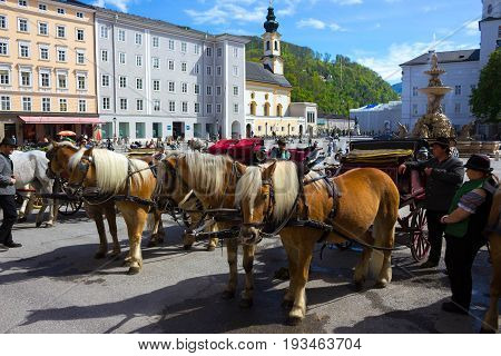 Salzburg, Austria - May 01, 2017: Central place in Salzburg city , Austria with carriages and horses at Salzburg, Austria on May 01, 2017