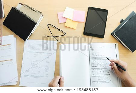 Close up of studying student hands writing in book during lecture education students college of university Reading Learning technology and Exam. Education concept top view.