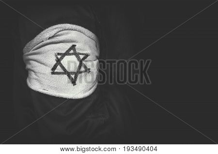 shoulder patch Jewish star of David in concentration camps in Germany. The concept of the genocide of the Jews. The day of memory of victims of the Holocaust. black and white retro photo