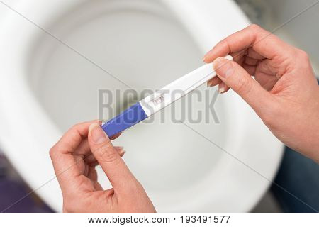 Woman Holding Positive Pregnancy Test. Concept Photo.