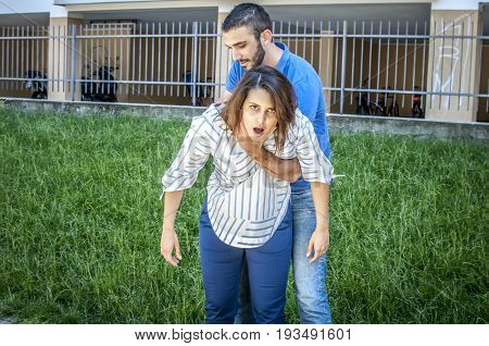 guy making the heimlich maneuver to a girl while she's chocking