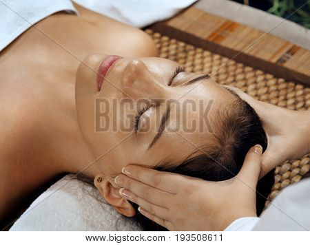 portrait of young beautiful woman relaxing in spa environment