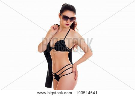 hot skinny girl with nice body in black lingerie and in glasses posing in Studio isolated on white background