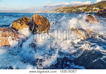 The sea waves are breaking waves with the orange stones.