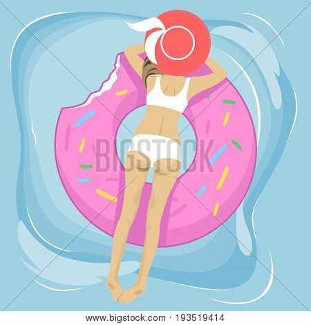 Sexy woman and an inflatable swim ring in shape of a donut in the pool