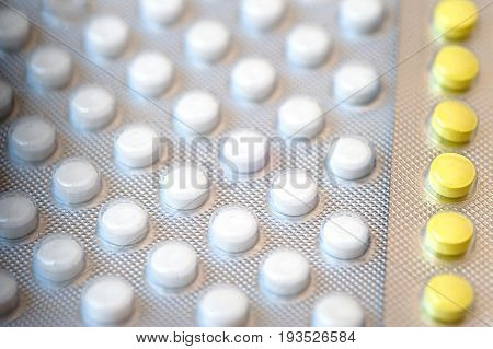 medicine Yellow and white pills in packs.Pills in blister pack, Capsules and pill packed in blisters