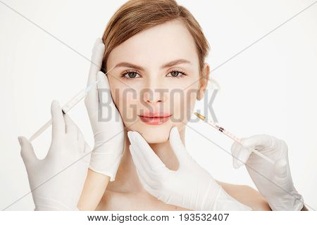 Cosmetologists hands making medical botox injections to beautiful blonde. Skin lifting. Facial treatment. Beauty and spa. Copy space.
