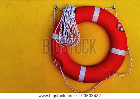 Life saver buoy hanging in a yellow wall of seaship. Greece, Corfu