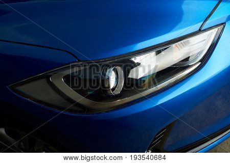 Clean modern car headlight close-up. Polished car frontlight