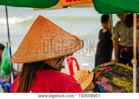 Muine Vietnam - May 26 2017: Unidentified Woman Wearing A Traditional Hat Shopping In The Seafood Fresh Market At Muine Pier In Muine Vietnam.