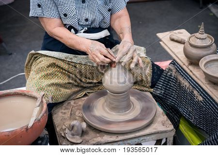 Senior Potter's Hands Shaping Decorative Clay Hollow Sculpture Tip On Pottery Wheel With Cloth