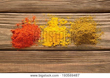 Spice powder on a wooden background. Close-up. Top view.