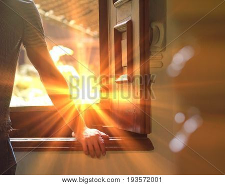 Rear view of a cropped man looking trough window